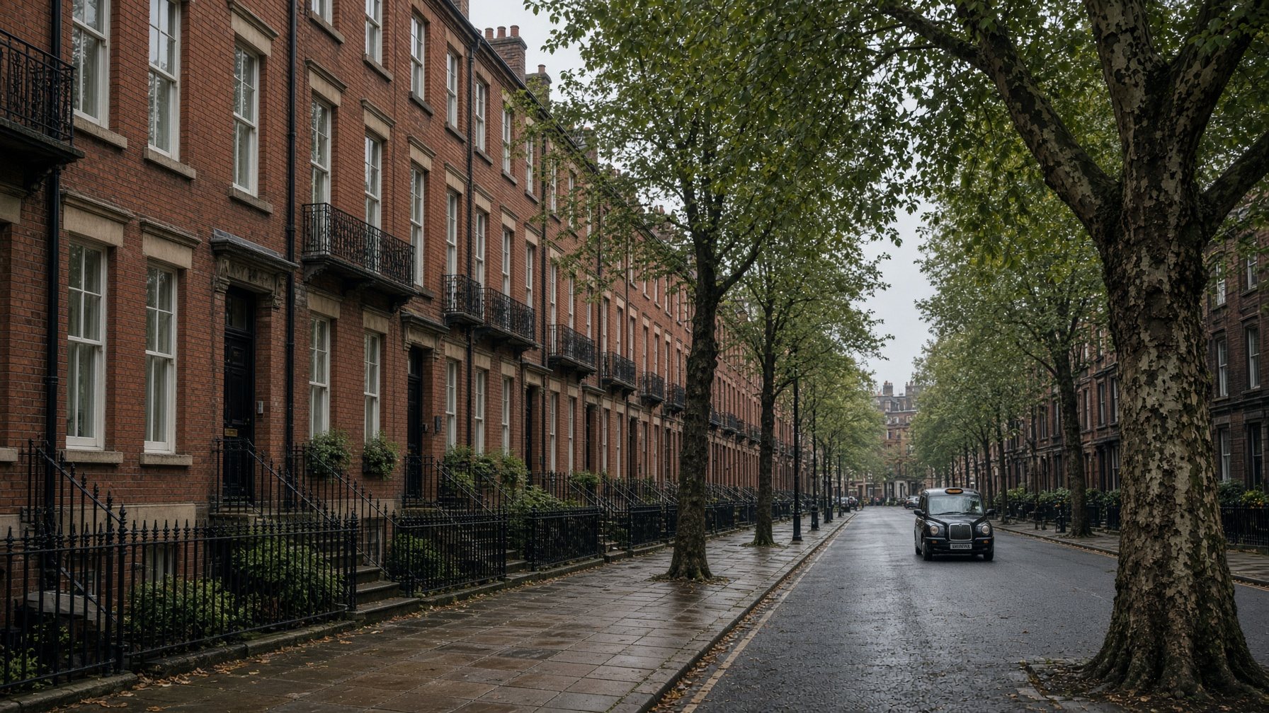 Red-brick Manchester street with iron railings and sash windows